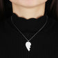 Sterling silver couple necklace featuring a unique heart design worn by a person with a black sweater.